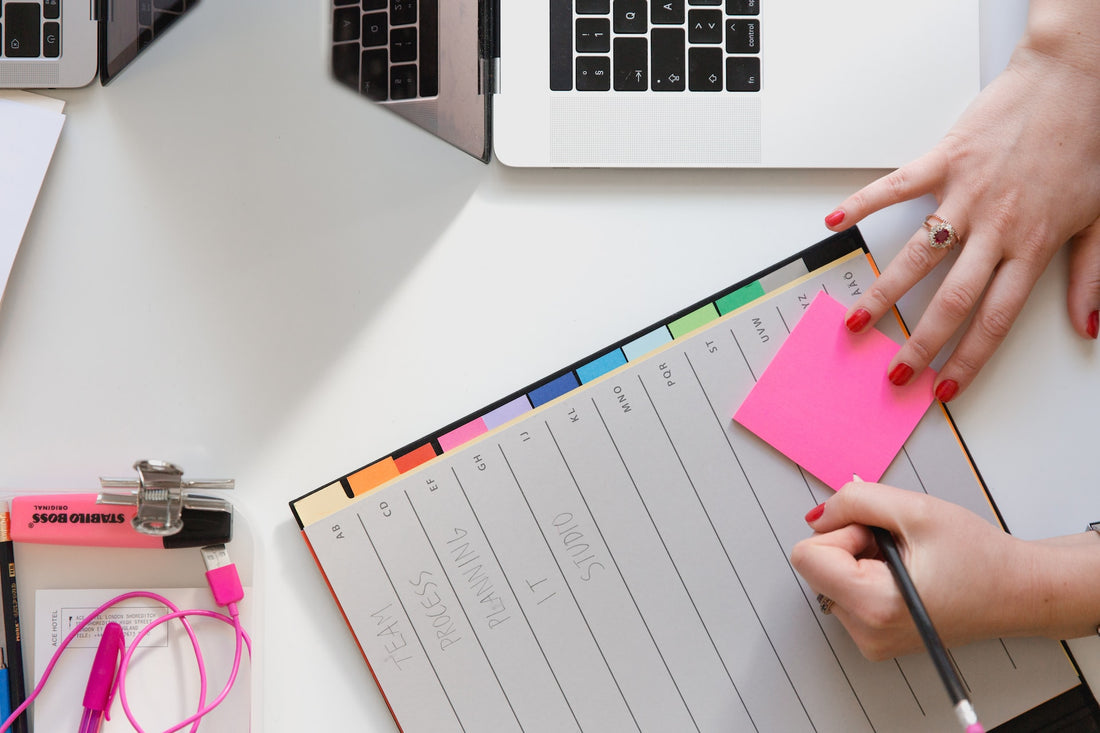 A sticky note, a folder and colourful tabs.